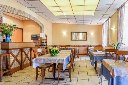ein Restaurant mit Tischen und Stühlen in einem Zimmer in der Unterkunft Hotel Acapulco in Lourdes