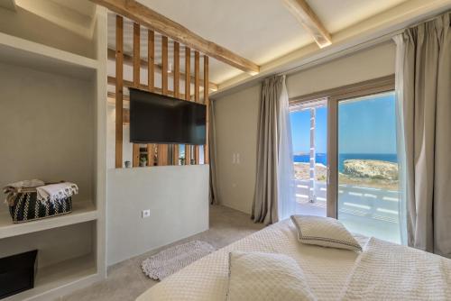 a bedroom with a bed and a large window at Ocean Pearl Luxurious Suite in Pachaina