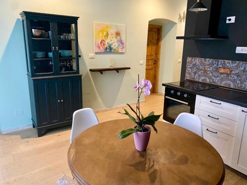 a kitchen with a wooden table with a plant on it at La Chicca del Centro in La Spezia