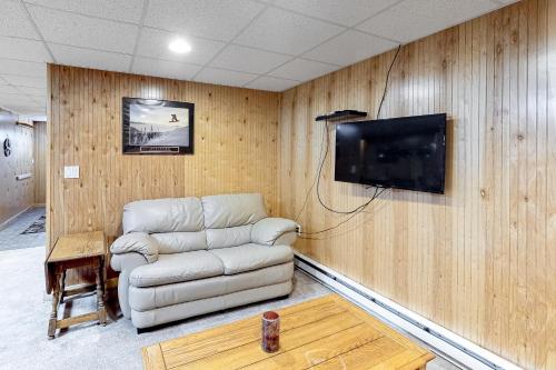 a living room with a couch and a flat screen tv at Swaying Pines in Wilmington