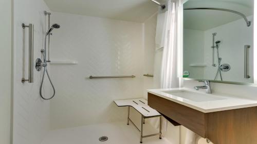a white bathroom with a sink and a shower at Holiday Inn Staunton Conference Center by IHG in Staunton