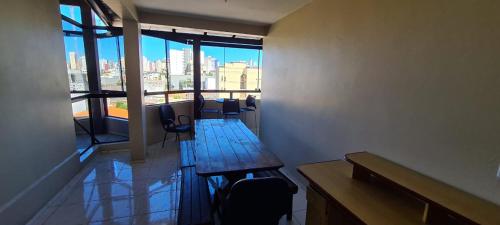 a waiting room with chairs and a large window at Hotel Costa Dalpiaz in Torres