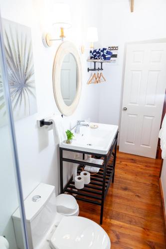 a bathroom with a sink and a toilet at Angeli Gardens Boutique Hotel in San Pedro Sula