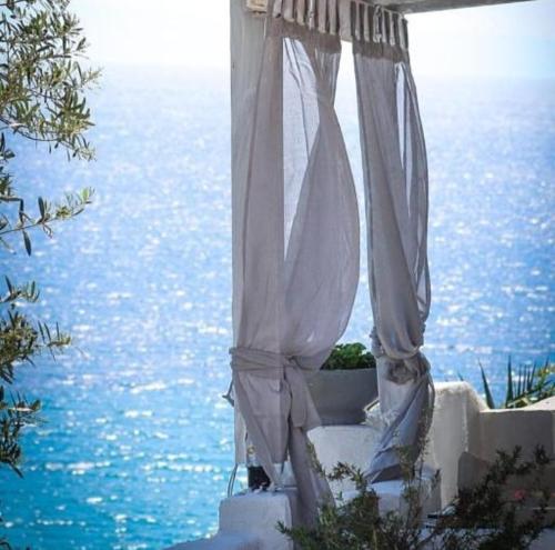 a white tent with the ocean in the background at Villa Olga studios in Nea Skioni