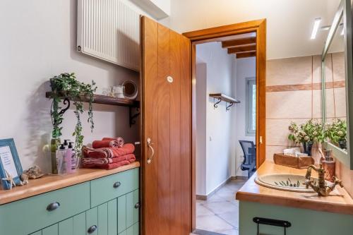 a kitchen with a wooden door and a sink at Villa Maja in Skopelos Town