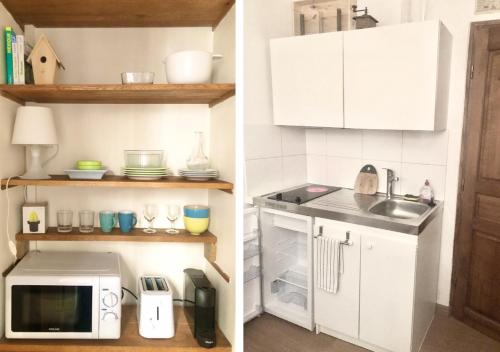 une cuisine avec des armoires blanches, un évier et un micro-ondes dans l'établissement Maison pour vous - TinyHouse center of Paris - logement insolite #MaCabaneAParis, à Paris