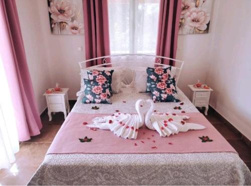 a bedroom with a bed with two dolls on it at Villa Vicky Corfu in Agios Ioannis