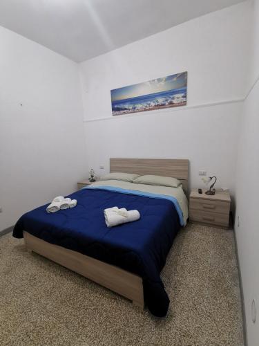 a bedroom with a bed with two towels on it at Villa Malese in Porto Cesareo