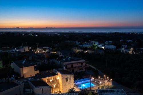 a view of a city at night at Alexandros 3 in Skouloúfia