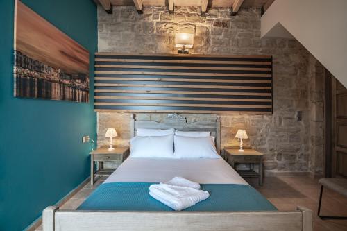 a bedroom with a large bed with towels on it at Alexandros 3 in Skouloúfia