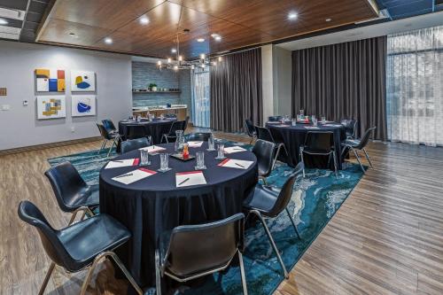 a conference room with tables and chairs in it at Hotel Indigo Spring - Woodlands Area by IHG in Spring