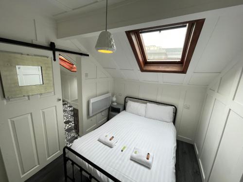 a small bedroom with a bed in a tiny house at Elmora House in Blackpool