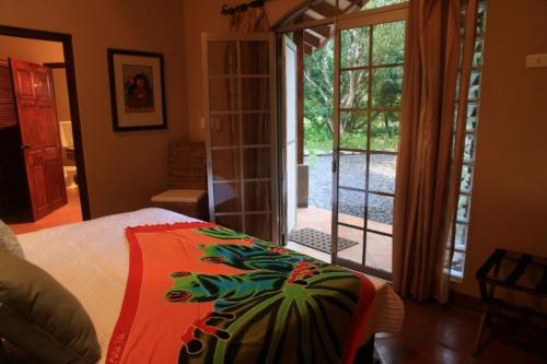 a bedroom with a bed and a sliding glass door at Private Pool & WiFi in Puntarenas