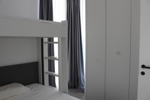 a bedroom with a bunk bed and a window at Villa Cristal in Vlorë