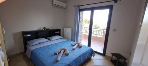 a bedroom with a bed with two teddy bears on it at 'The Seagull' Traditional Cottage in Nea Makri
