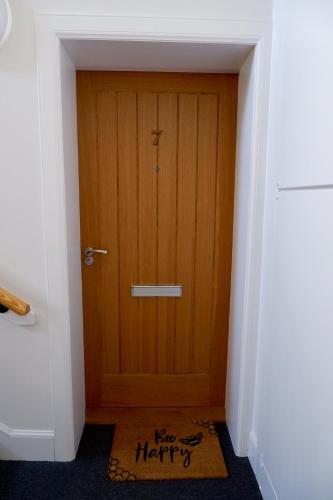 a hallway with a wooden door with the words happy birthday at No 7 Quiet, two bedroom Ground Floor Flat in Tornagrain Great for early Airport departures or late flights in Dalcross