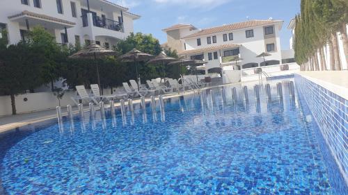a large swimming pool with chairs and umbrellas at Casa Di Gio in Tersephanou