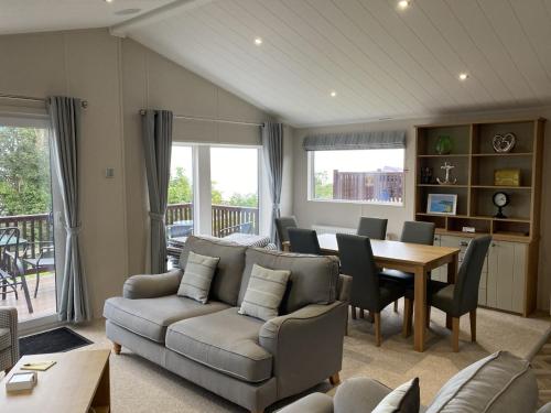 a living room with a couch and a table at Coastal View in Brixham