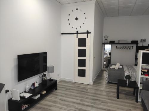 a bedroom with a bed and a cross on the wall at APARTAMENTO TURISTICO LYRA BAENA in Baena