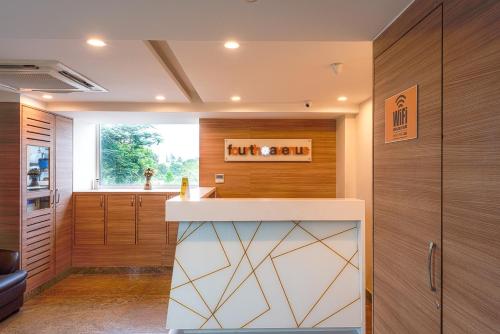 a kitchen with wood paneling and a counter top at Treebo Fourth Avenue in Chennai