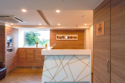 a kitchen with wood paneling and a counter top at Treebo Trend Fourth Avenue in Chennai