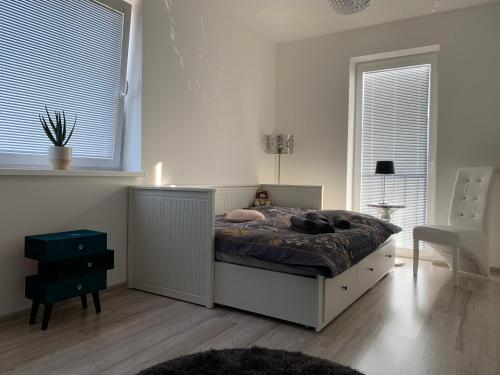 a bedroom with a bed with a teddy bear on it at Modern 2 bed house near Bratislava with parking in Rovinka