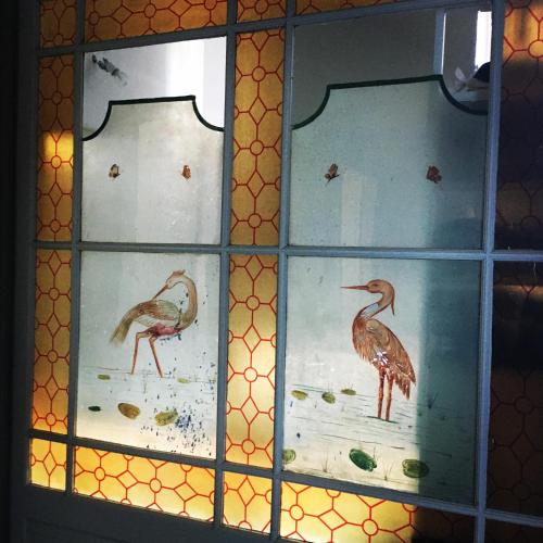 three stained glass windows with birds on them at LaFabriek in Canet d'Aude