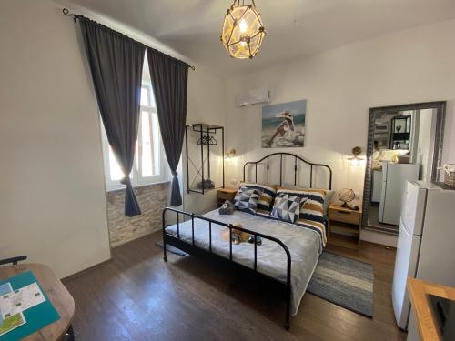 a bedroom with a bed and a living room at LukaDoraJana Pula City Center in Pula