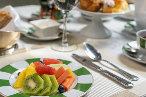 a plate of fruit sitting on a table at Alvear Icon Hotel in Buenos Aires