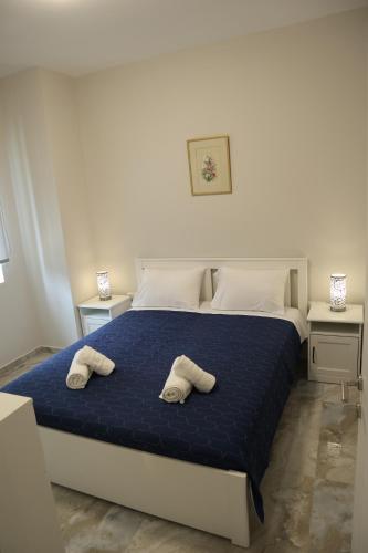 a bedroom with a bed with two towels on it at Catherine's Comfort Apartment No1 in Lavrio