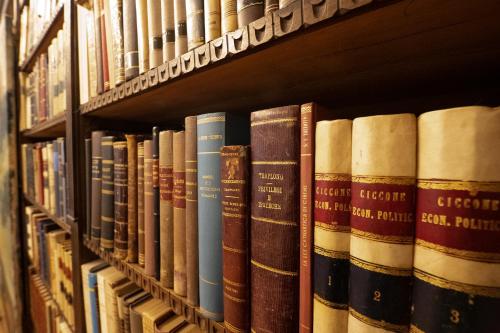 a row of books on a library shelf at Book and Bed in Orvieto