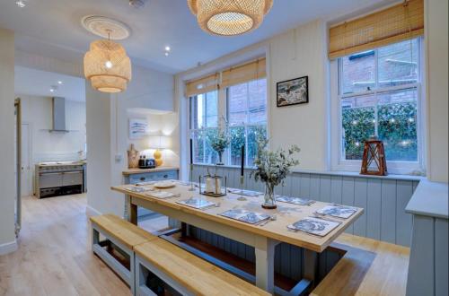 a kitchen with a wooden table in the middle at Sea View, Beach Road, Cromer in Cromer