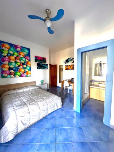 a bedroom with a bed and a painting on the wall at B&B Villa Regine camera con terrazza a Forio in Forio d'Ischia