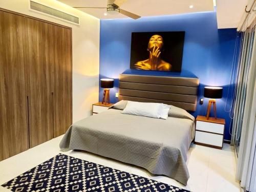a bedroom with a bed with a statue on the wall at Luxury 2 bedroom beach front at Nuevo Vallarta in Nuevo Vallarta 