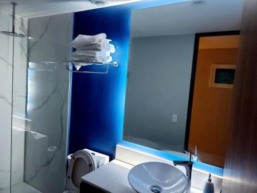 a bathroom with a toilet and a sink and a mirror at Luxury 2 bedroom beach front at Nuevo Vallarta in Nuevo Vallarta 