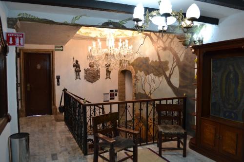 a room with a staircase with a painting on the wall at Hotel Boutique La Mansión Guadalajara in Guadalajara