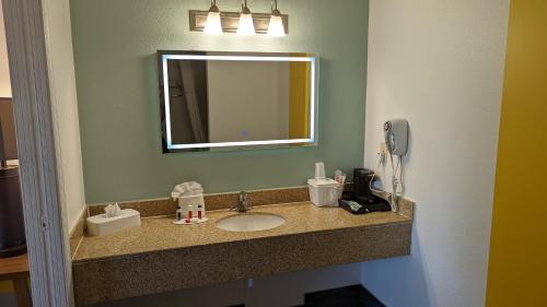 a bathroom counter with a sink and a mirror at Days Inn by Wyndham Lake Havasu in Lake Havasu City