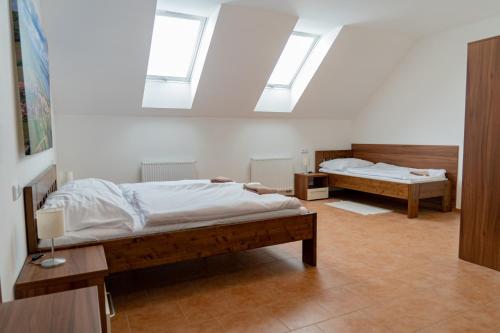 a bedroom with two beds and two skylights at Pension Florián in Pavlov