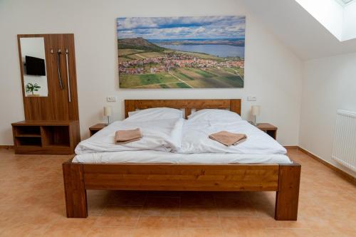a bedroom with a bed with a painting on the wall at Pension Florián in Pavlov