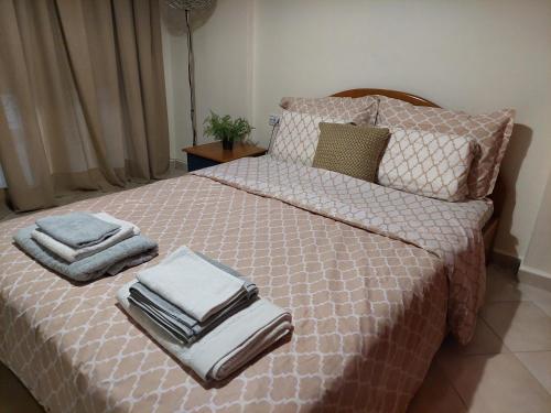 a bedroom with a bed with towels on it at Κλινάρι in Xanthi