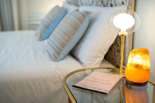 a glass table with a piece of cake on it next to a bed at Casa di Carlo Goldoni - Dimora Storica in Chioggia
