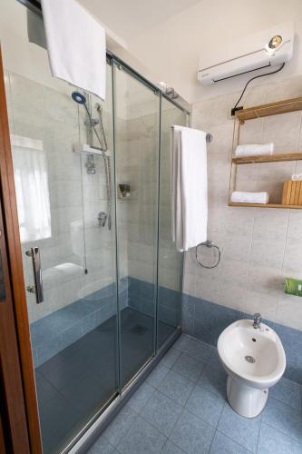 a bathroom with a glass shower and a toilet at Casa di Carlo Goldoni - Dimora Storica in Chioggia