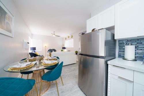 a kitchen with a table and a refrigerator at The Surf Hollywood Beach in Hollywood