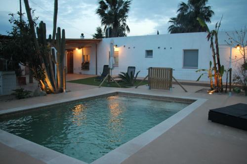a swimming pool in front of a house at L'Hortet del iaio in Camarles