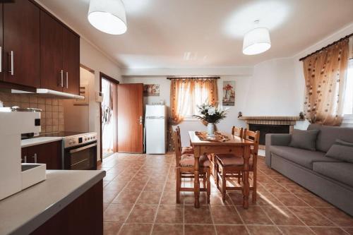 a kitchen and living room with a table and a couch at DINA'S Apartment in Kos in Kaká Pinári