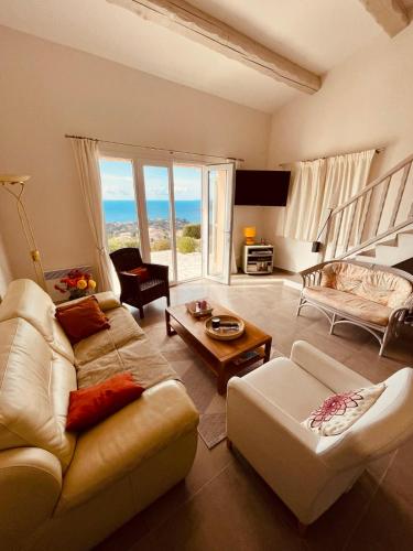 un salon avec un canapé et une table dans l'établissement Bastidons pour six personnes vu Méditerranée, à Agay