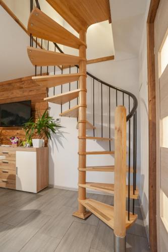 a wooden spiral staircase in a home with wooden floors at Domek JuKa in Biały Dunajec