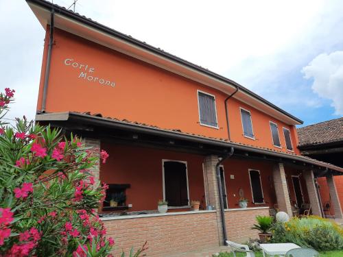 an orange building with a sign that reads cottage kitchens at CORTE MORONA in Marmirolo