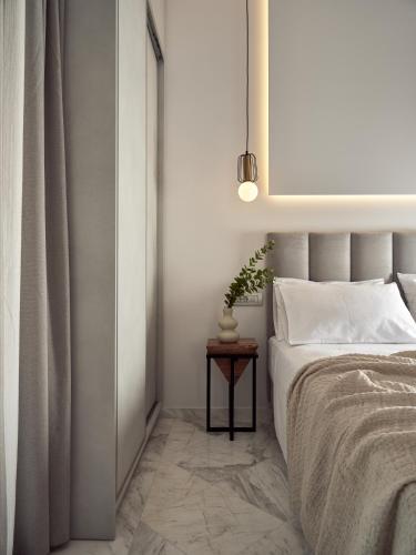 a bedroom with a bed and a side table with a lamp at Vis di Vardi Luxury Estate in Zakynthos Town