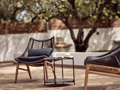 two chairs and a table with a book on it at Vis di Vardi Luxury Estate in Zakynthos Town